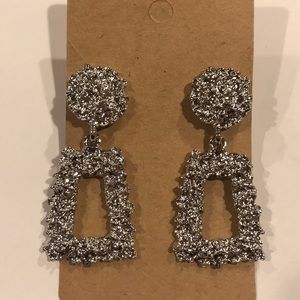 Silver colored diamond cut textured earrings